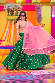 Photo Of Bride Dancing Wearing Green And Pink Lehengas On Mehendi Lehenga Designs Indian Outfits Wedding Lehenga Designs