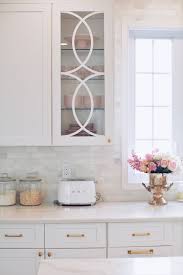 Installing new panels in old cabinet doors can really dress up a kitchen (and new cabinet door panels are a lot cheaper than new cabinets). Mullion Cabinet Doors How To Add Overlays To A Glass Kitchen Cabinet The Pink Dream