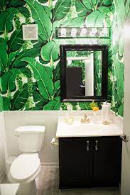 This banana leaf wallpaper is a fraction of the price and removable! Amelia Canham Eaton S Chicago Apartment The Everygirl Bathroom Wallpaper Leaf Wallpaper Powder Room Wallpaper