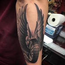 Keep On Riding With These 11 Wheel Tattoos In 2021 Wheel Tattoo Biker Tattoos Wings Tattoo