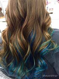 Searching for a new style for your brown tresses and wish to follow trends? Brown Hair With Blue Peekaboos Blue Hair Highlights Blue Tips Hair Blue Ombre Hair