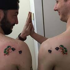Maybe you would like to learn more about one of these? Brothers Pixel Video Game Tattoo Idea