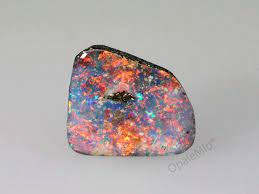 Boulder opals are easily distinguished by their layer of solid brown ironstone left on the back of the stone. Black Boulder Opal
