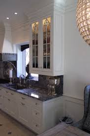 Gothic inspired built in featuring applied molding on doors and large glass display cabinets with victorian cathedral inspired detail. Gothic Kitchen In Rye Ny British Colonial Kitchen New York By Jem Woodworking Cabinets