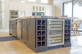 A black kitchen island pushed up against the wall doubles as a home bar in this kitchen in a small apartment remodeled by thibaut and thewood, a wood workshop based in france. Kitchen Island Storage How To Make The Most Out Of It Cornerstone Cabinet Company