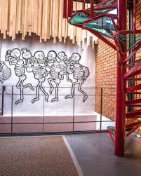 The home also features a large wall art with pink lighting. Loft Of The Red Spiral Staircase Arqflores Archello