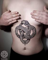 Black Ornamental Ouroboros Tattoo On The Belly Ouroboros Tattoo Badass Tattoos Polynesian Tattoo