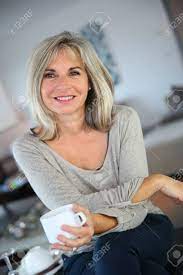 In conclusion, striped or printed dresses, midi skirts and cropped or flared pants are more fashionable than ever. 50 Year Old Woman At Home Drinking Tea Stock Photo Picture And Royalty Free Image Image 23904891