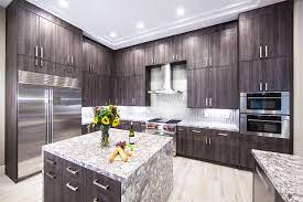 These Frameless Aspen Oak Cabinets Cover These Kitchen Walls With Beauty And Functional Storage Kitchen Cabinet Remodel Kitchen Design Custom Kitchen Cabinets