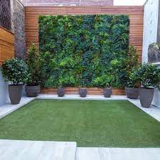 Highlight the fence and on the existence of a trend in the field. Privacy Fence Constructed With Fake Plant Panels Makes Beautiful Oasis Vertical Garden Design Vertical Garden Vertical Garden Design Ideas