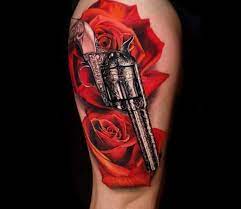 Gun tattoos are a common method of marking one's rebelliousness or outlaw ways. Gun And Roses Tattoo By Jurgis Mikalauskas Post 28351