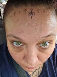 Image result for quirky pylon forehead tattoo