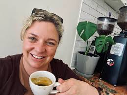 Girl working at Genius Bar with coffee and quiche