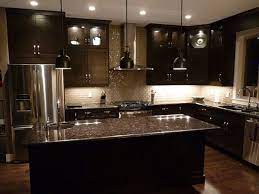 Black leathered countertop on a black shaker kitchen island fitted with a set of vintage brown spindle counter stools in a transitional kitchen design. Kitchen Custom Black Contemporary Kitchen Cabinets Elegan Lamp Decor With Modern Stov Contemporary Kitchen Cabinets Backsplash With Dark Cabinets Dark Kitchen