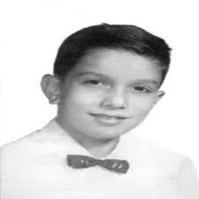 Fire Captain Richard Scheidt (1928-2009) Photo Description: Firefighter  Richard Scheidt rushes out of Our Lady of the Angels carrying 10-year-old  John Jajkowski. The boy was among the students who died in the