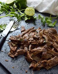 A long thin steak with visible muscle fibers running across the width of the steak. Carne Asada Recipe Wonkywonderful