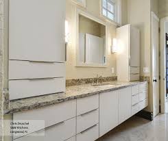 It features a spacious cabinet interior with 3 shelves. Modern Bathroom With Slab Cabinet Doors Omega