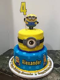 This minion cake uses delicious buttercream to frost the cake and fondant for the details. Minion 2 Tier Birthday Cake Minion Birthday Cake Tiered Cakes Birthday 2 Tier Birthday Cakes