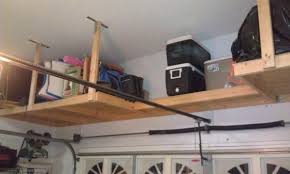 I am wanting to build some hanging overhead storage in my garage. Wooden Garage Ceiling Storage Garage Ceiling Storage Overhead Garage Storage Diy Garage