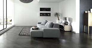 These Dark Stone Tile Floors Create Contrast With The Bright White Walls And Gray Furnishings The D Grey Tiles Living Room Living Room Tiles Living Room White