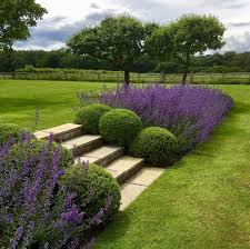 Simply Sloping A Once Unevenly Sloping Lawn Is Transformed Into Two Flatter More Usable Lawns Separate Sloped Garden Country Garden Design Country Gardening