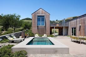 This house bridges between two stands of redwood trees, with the northern window wall facing out to the expansive view. West Marin Residence By Turnbull Griffin Haesloop Homeadore