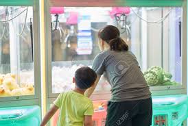 When you want to pull out all the stops: Mom And Boy Play Playing Vending Machine The Dolls Get By Insert Stock Photo Picture And Royalty Free Image Image 121178890