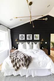 It features modern furnishings in white colors and wooden materials to warm up the intensity created by the black interior paint color. Black And White Modern Master Bedroom Bright Green Door
