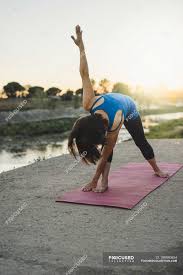 All yoga pants aren't created equal, though. Mature Woman Outdoors Bending Over In Yoga Position Water 40 To 44 Years Stock Photo 199890854