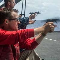 Retired Master Sgt. Richard Thomas fires his pistol