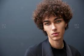 The fade haircut has normally been accommodated men with short hair, however lately, individuals have been combining a high fade with tool or long hair on top. London England June 11 2017 Close Up Portrait Of Mixed Race Young Male Fashion Model Against Black Wall During London Fashion Week Men S Stock Photo Offset