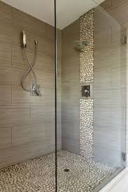 Love The Pebbles On The Floor Free Daily Foot Massage Might Switch The Vertical Column To Glass Tiles To Bathroom Trends Bathrooms Remodel Bathroom Makeover
