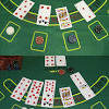 Once looking at their cards, a player decides whether they are in or out, starting to the left of. 1