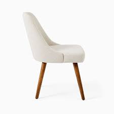 This nordic style dining room features warm brown chairs and matching dining table. Mid Century Upholstered Dining Chair Wood Legs West Elm Canada