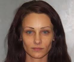 Woman booked in shooting flashes officer, gets re-arrested