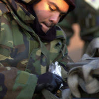 US Air Force STAFF Sergeant Mark Staub struggles to loosen a tie-down from  a GBU-10 at Osan Air Base, Republic of Korea, during Osan's Initial  Response Readiness Exercise/Combat Employment Readiness Exercise -