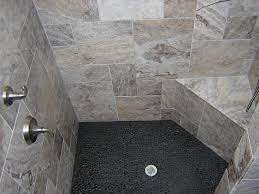 The downsides to having a pebble shower floor are as follows: Image Result For Black River Stone Shower Floor Shower Tile Shower Floor Pebble Tile Shower Floor