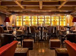 Dining room, wall lighting, medium hardwood floor, stools, and bar. Lounge Luxury Decor The World S Finest Iconic Lounge Bar Seating Restaurant Interior Design