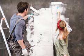 Pop the cork, enjoy a glass of wine while making this fun and easy crafts for couples. Young Couple Painting Wall Together Renovation Home Concept Stock Photo Dissolve