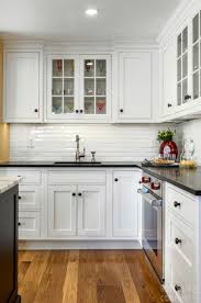 Traditional Kitchen With Farmhouse Flair Cabinetry Woodmode Brokhaven Cabinets Kitchen Black Counter Kitchen Cabinet Styles White Cabinets Black Countertops