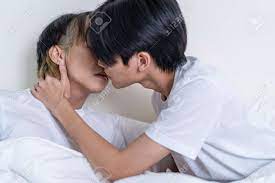 Asian Attractive Male LQBTQ Starting Foreplay And Making Love At Home.  Handsome Romantic Man Gay Couple Spending Leisure Time Together Having Sex  In Dark Night Room In House. Homosexual-LGBTQ Concept. Stock Photo,