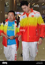 Incheon, South Korea. 16th Sep, 2014. Chinese swimming athlete Sun Yang (R)  and his coach Zhang Yadong walk out of the international airport in  Incheon, South Korea, Sept. 16, 2014. Some members