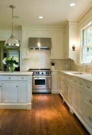 Gorgeous Kitchen With Ivory Cabinetry Pairing With Brushed Nickel Hardware Stone Countertops And An Diy Kitchen Renovation Kitchen Design Kitchen Inspirations