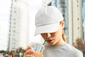 12 free photorealistic cap & hat mockup | utemplates. Dad Hat Mockup Of A Woman With A Beverage Free Mockup