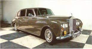 A Rolls-royce Phantom V Limousine Was Parked In The Driveway And A Chauffeur Was Running A Dust Cloth Over Its Antelo Rolls Royce Rolls Royce Phantom Limousine