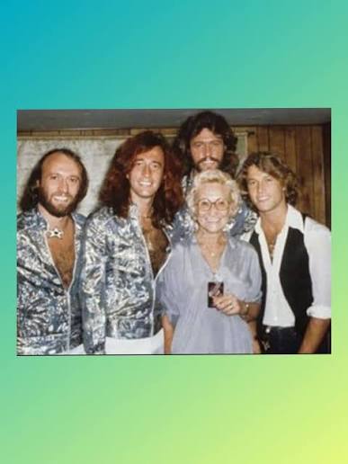 British musicians and brothers Maurice Gibb, Robin Gibb, and Barry Gibb of pop group Bee Gees performing and filming at foot of Nelson's Column, Trafalgar Square, London, UK, 15th October 1973.