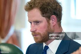 Prince Harry talks with Alejandro Becker of the Tim McGraw... News Photo