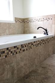 Be realistic about the size of bathtub that will fit in your bathroom. This Beautiful Garden Tub Is Surrounded By Bordeaux Marron Tile With Tranquil Ashen Forest Decorative Tile And Cottage Bathroom Bathroom Redo Tub Tile Ideas
