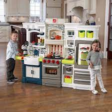 It features a variety of realistic appliances, including a microwave, refrigerator, oven, stove, and sink. 15 Play Kitchen Sets Ideas Play Kitchen Sets Play Kitchen Kitchen Sets