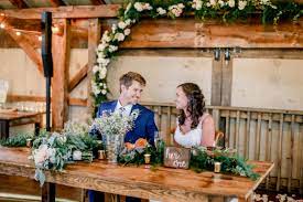 Bride And Groom At Rustic Sweetheart Table Stacy Salvatori Photography Indoor Wedding Receptions Rustic Sweetheart Table Barn Wedding Venue